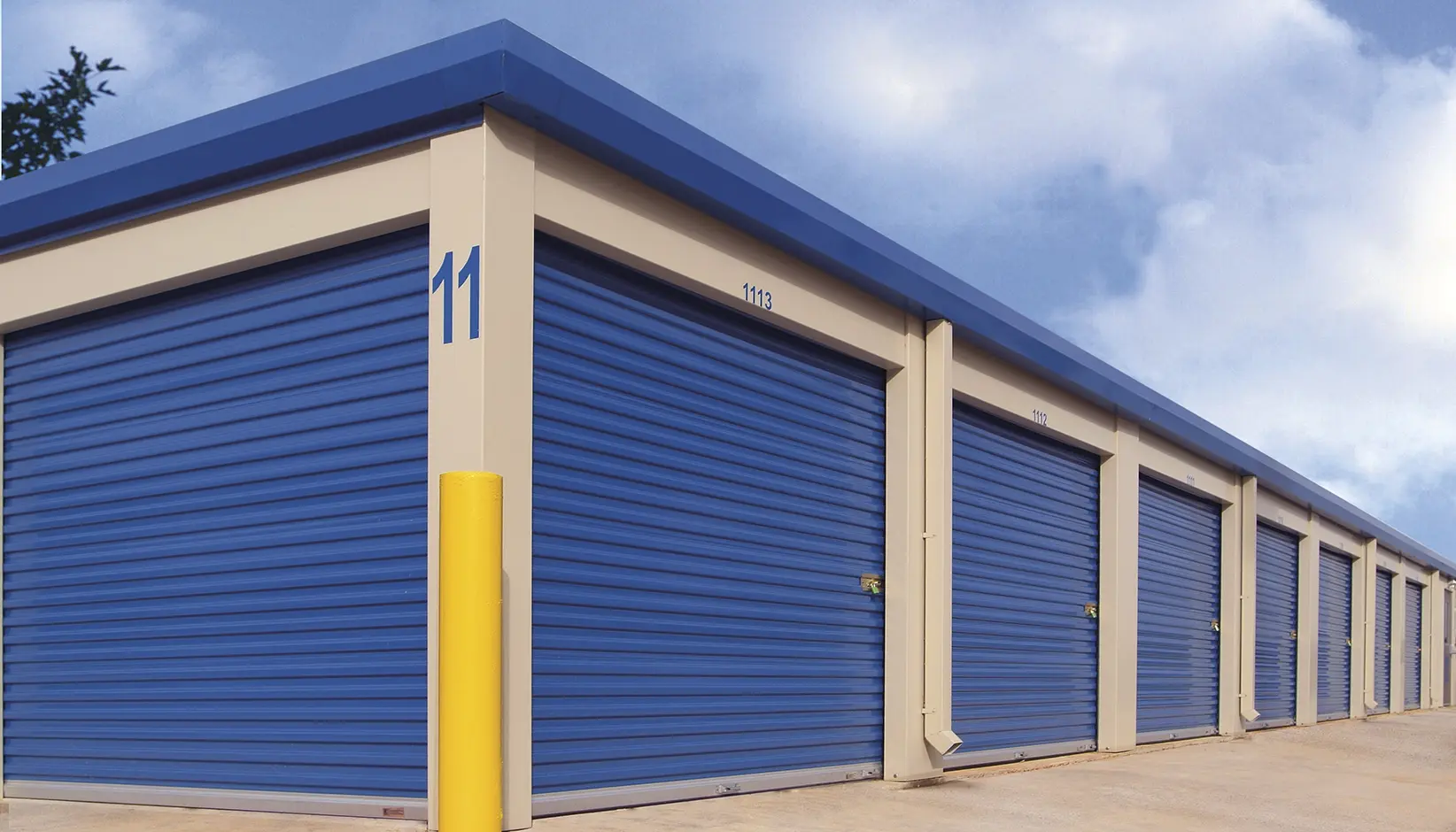 Blue commercial roll-up doors on storage units